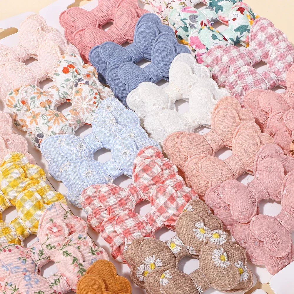 Close-up of assorted baby bowknot cotton hair clips in pastel patterns