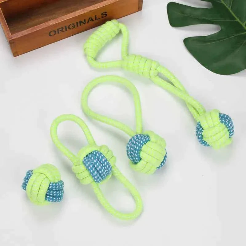 Braided cotton rope dog toys laid out: green rope handles with blue rope balls