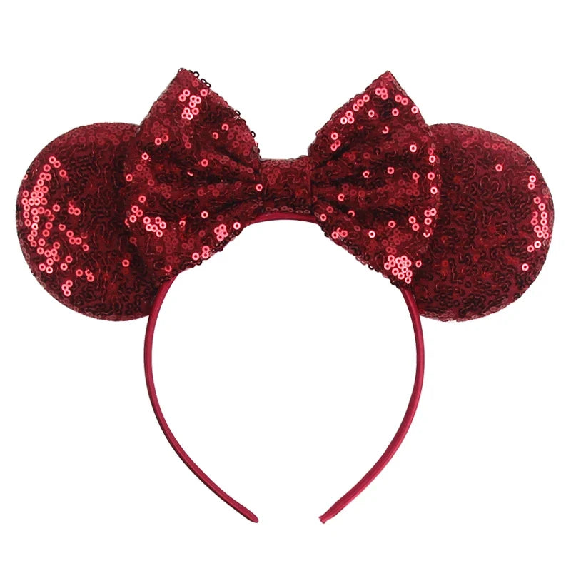 Red sequin Mickey-style ears headband with bow, shiny sequins and curved band.