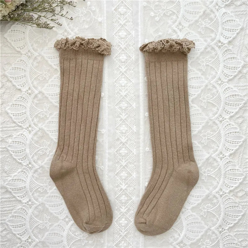 Knee-high ruffle socks with lace cuff, khaki beige pair laid flat