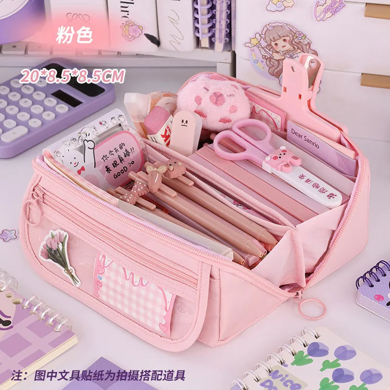 Light pink zip pencil case open with pencils and stationery in side pouches