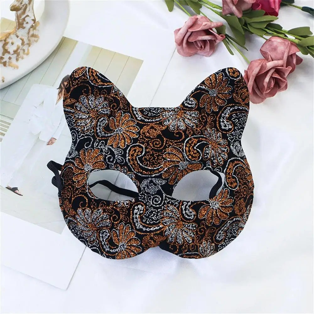 Brown and orange patterned cat masquerade mask with glitter swirls, eye cutouts, ribbon ties