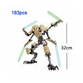Buildable robot action figure in black and tan armor, standing with blue and green sabers