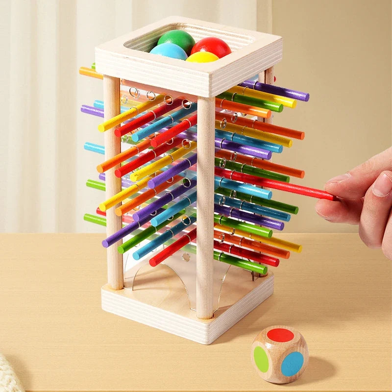 Wooden stick battle tower with colorful sticks and a hand placing a stick