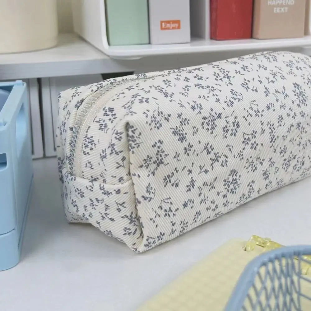 Large canvas pencil pouch with zipper, cream fabric with small blue-gray floral pattern