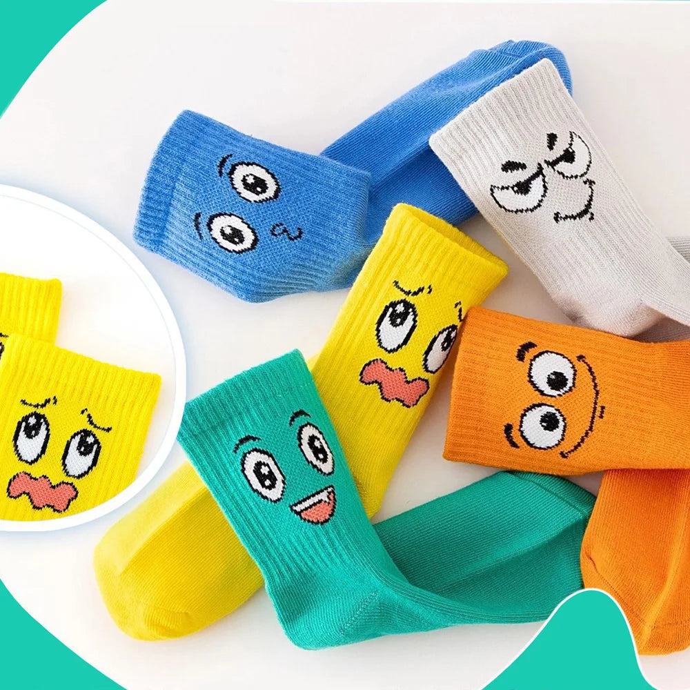 Kids crew socks 5-pair set featuring cartoon faces on teal, blue, yellow, orange, and white socks.
