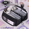 Black zip pencil case open with pens, markers, and front character patch panel