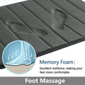 Close-up of dark grey bath mat surface with cushioned, textured texture
