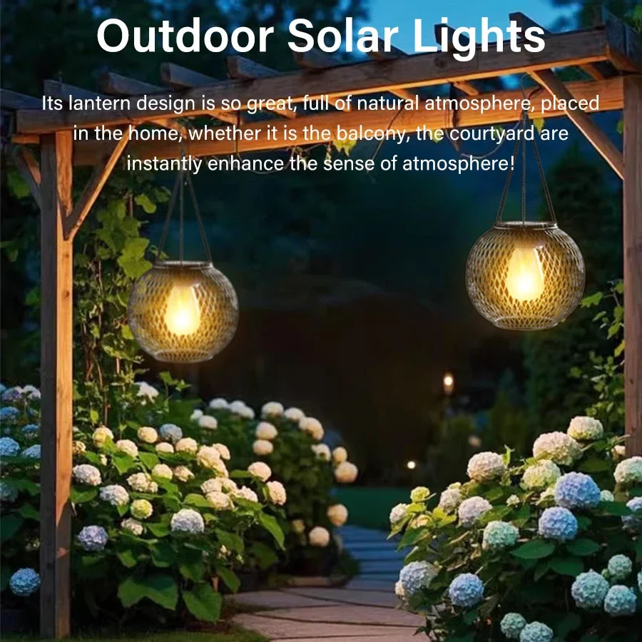 Outdoor solar hanging lantern with wire mesh globe emitting warm light