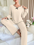 Women’s flannel pajama set with long sleeves, light beige with black trim and bow collar