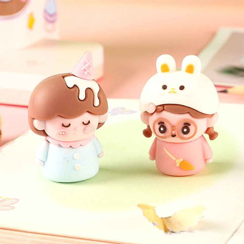 Two cute pencil sharpeners: ice cream cone figure and white bunny figure.