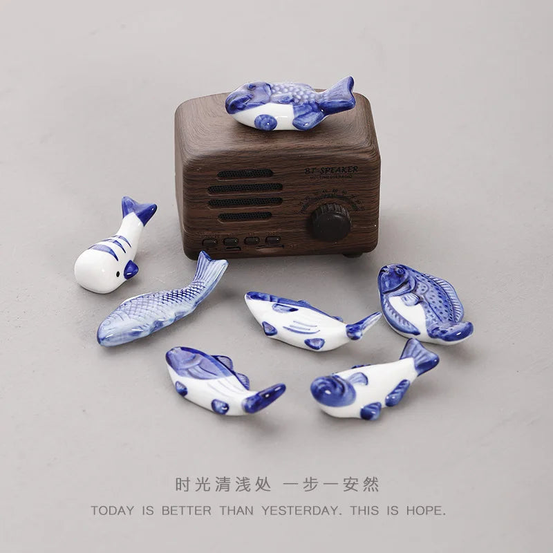 Ceramic fish chopstick holder set with several blue-and-white fish pieces