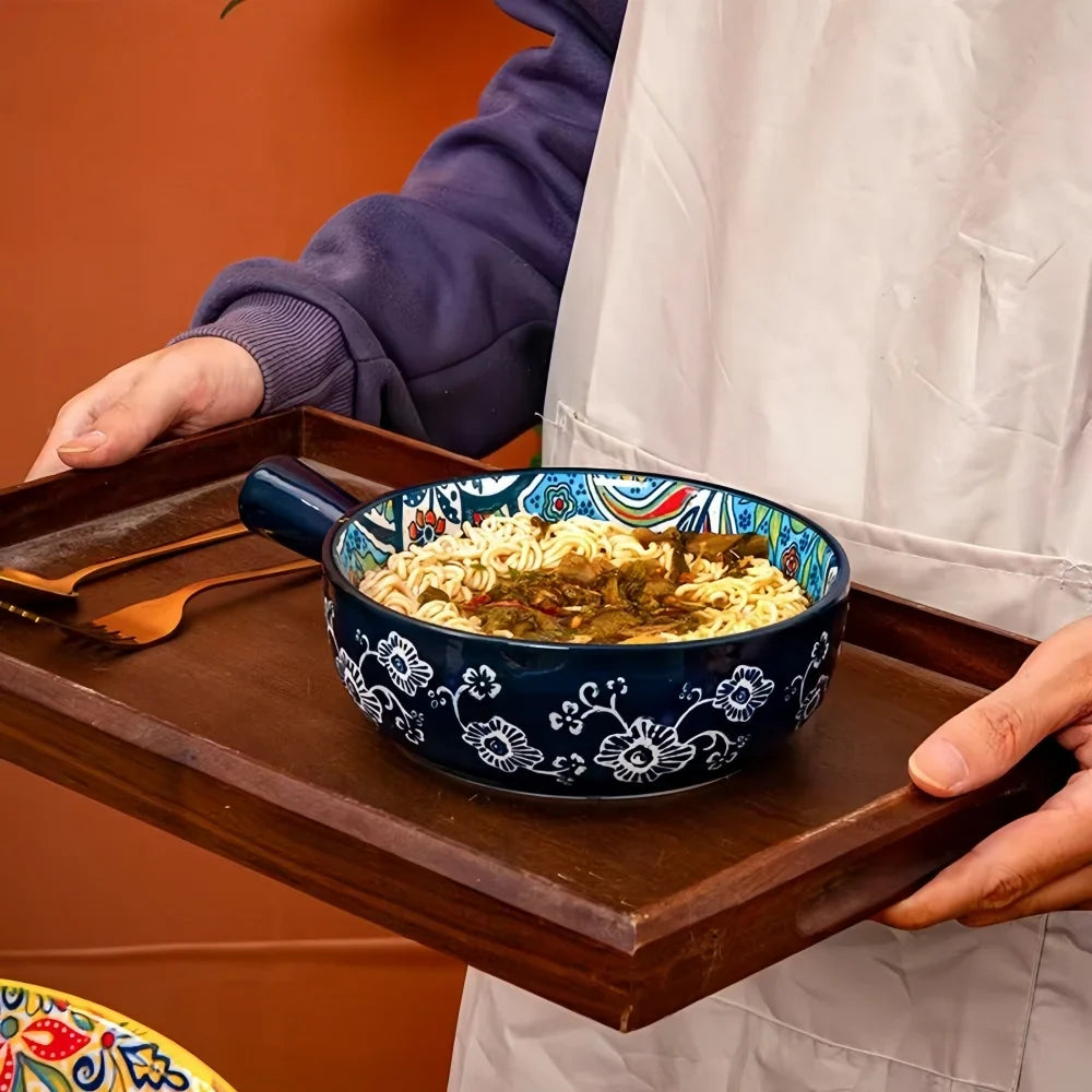 Ceramic salad bowl with navy pattern and blue handle, filled with food