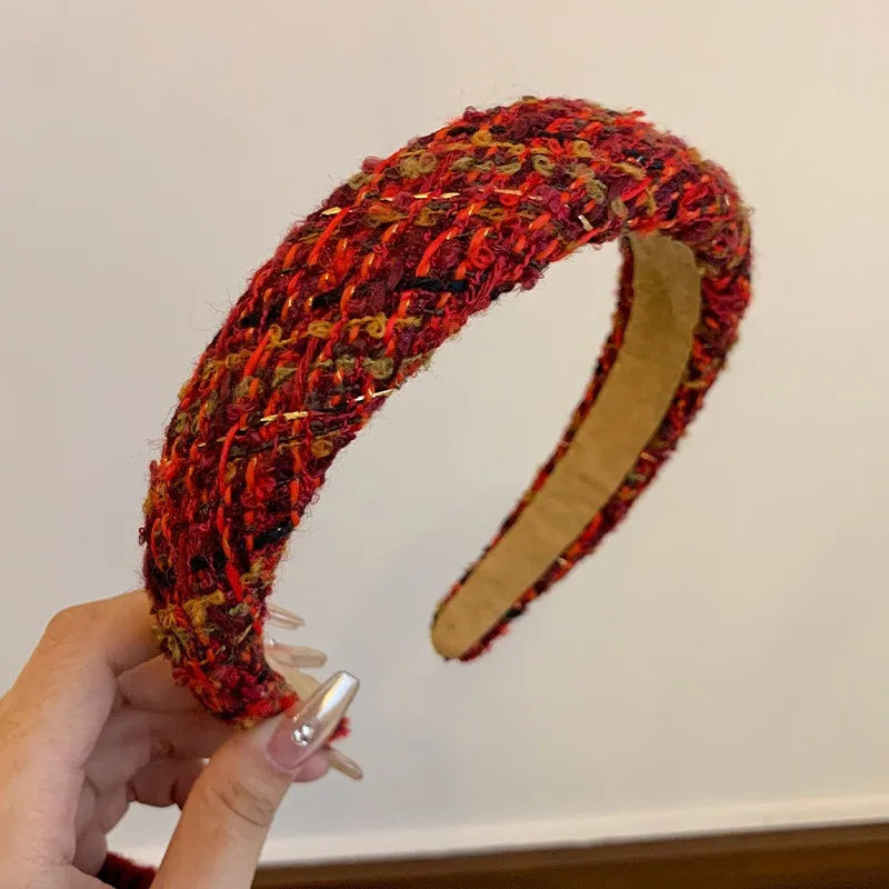 Red textured wide headband with woven pattern and tan inner grip