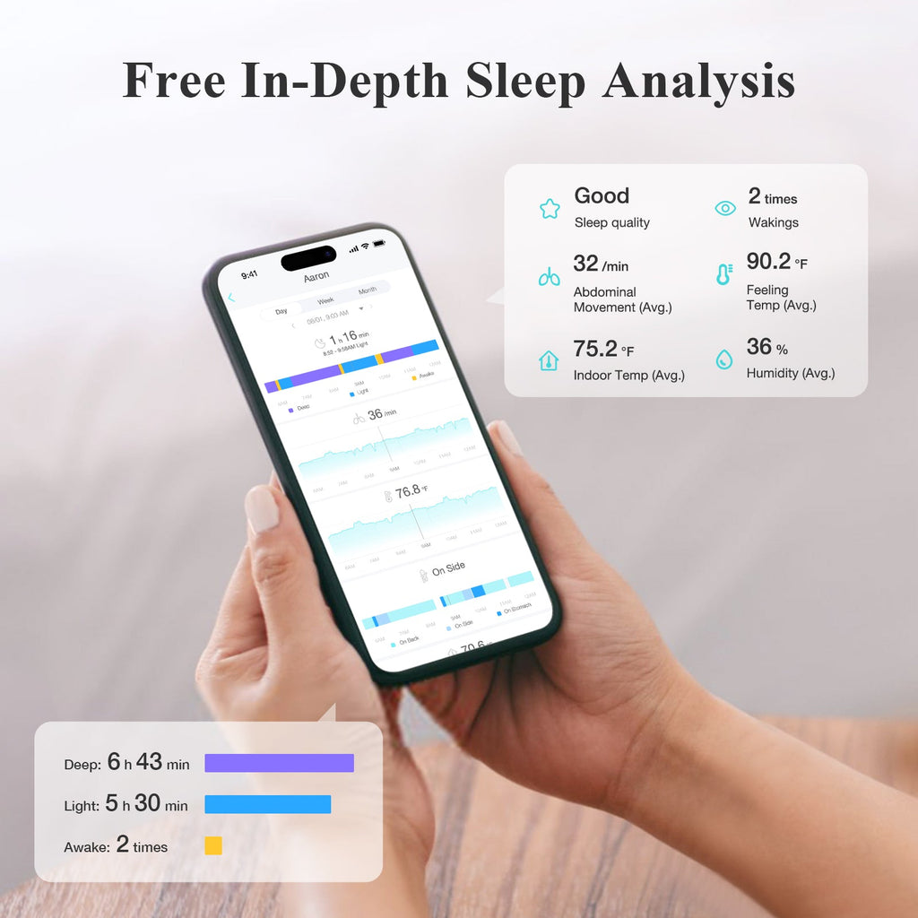 Hand holding smartphone displaying sleep analysis while white baby monitor base sits