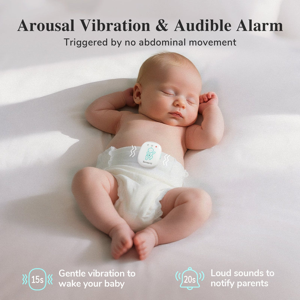 Baby monitor armband-style display near a sleeping baby on a soft surface
