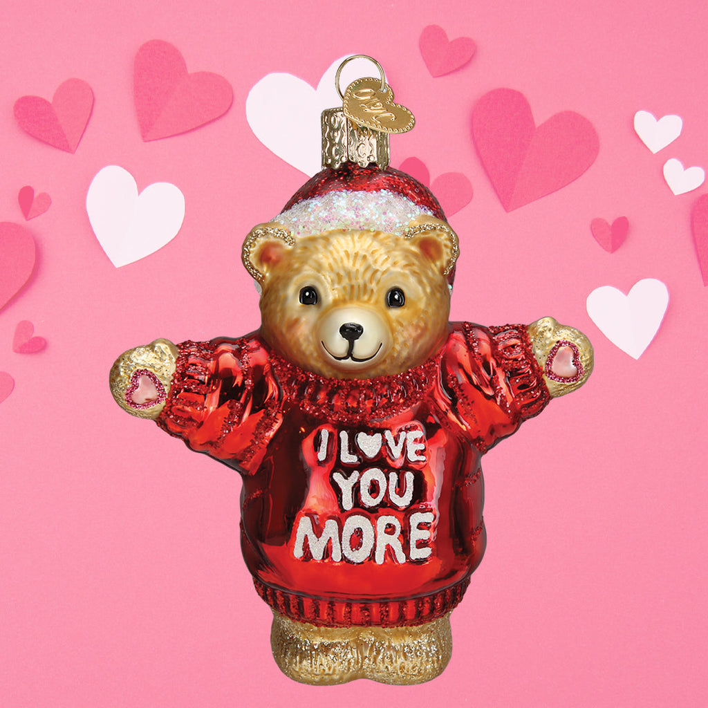 Hanging teddy bear ornament with red “I LOVE YOU MORE” sweater and glittery gold feet