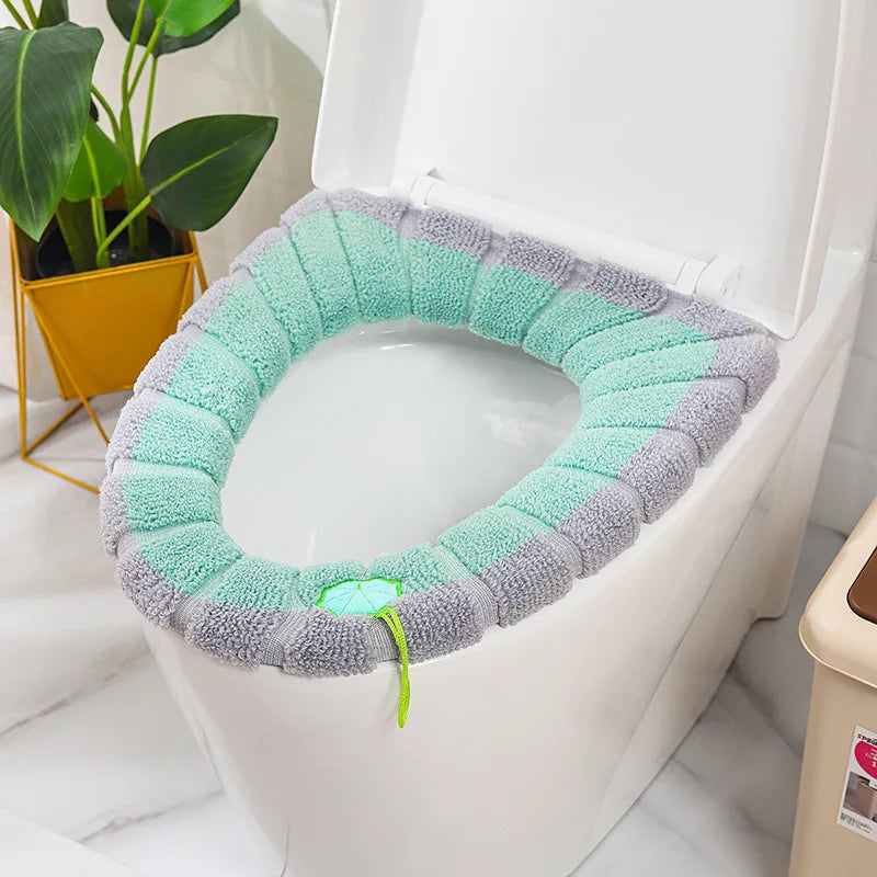 Turquoise and gray plush toilet seat cover mat with handle, soft terry fabric.