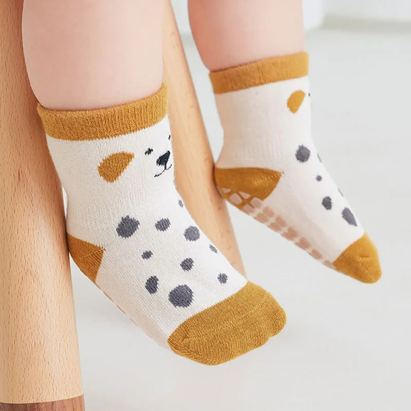 Kids non-slip floor socks with dalmatian-style spots and brown trim, grippy sole