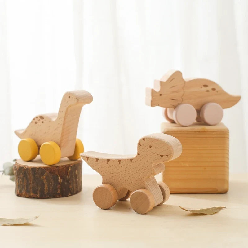 Wooden dinosaur teether car with yellow wheels and tan wooden body