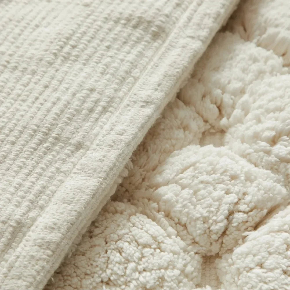 Ivory bath rug edge with textured loop pile and stitched border close-up