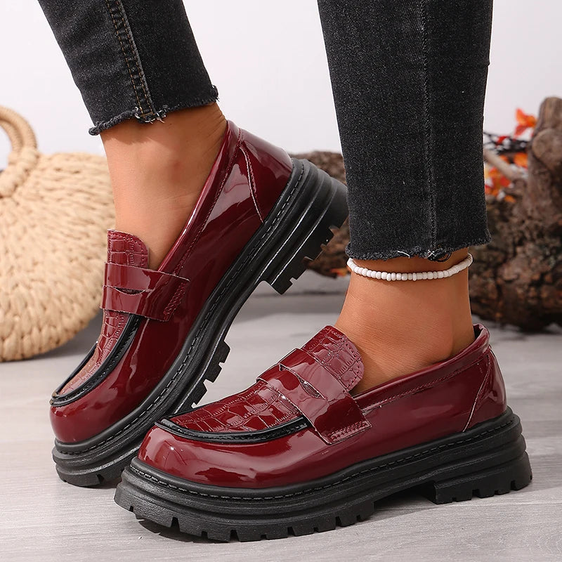 Red patent platform loafer with glossy finish, chunky ridged sole, round toe