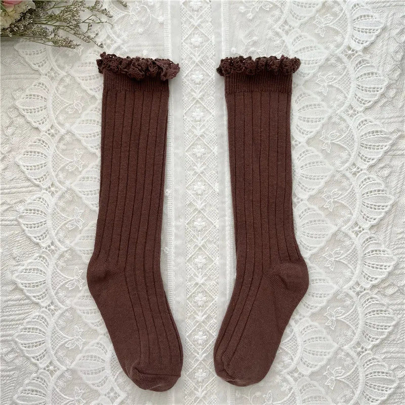 Knee-high ruffle socks with lace cuff, dark brown pair laid flat