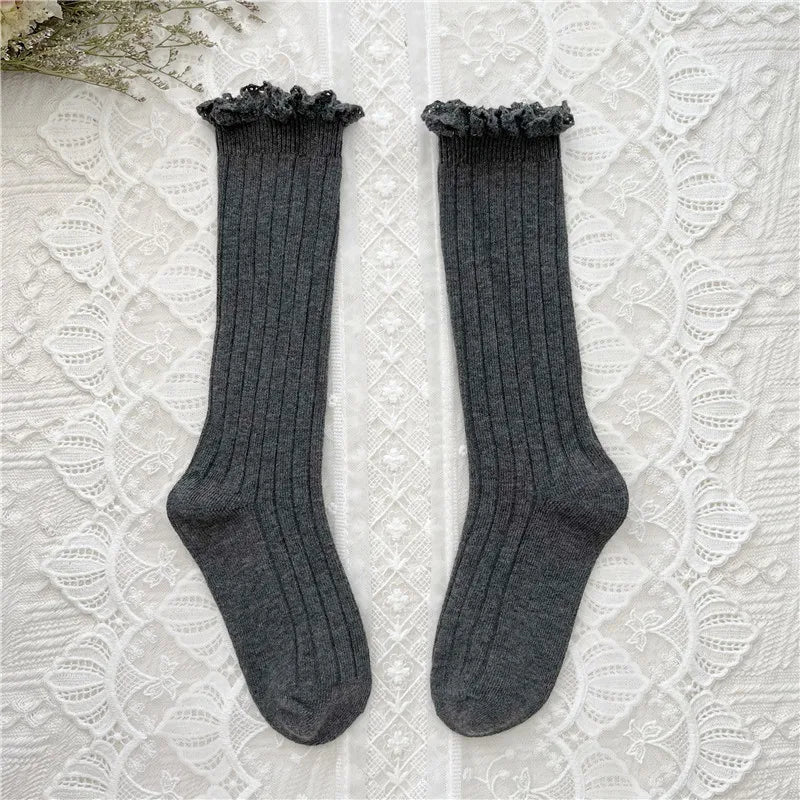 Dark grey ribbed knee-high socks with ruffled cuff