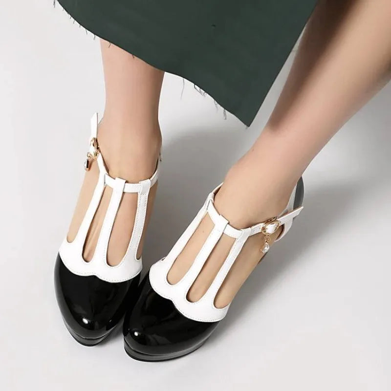 Women’s heeled Mary Jane shoes, black glossy toe with white T-strap, gold-tone buckle charm