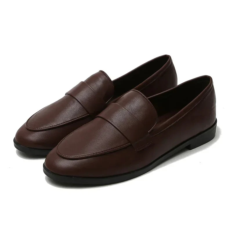 Dark brown slip-on leather loafers with round toe and stitched apron detail