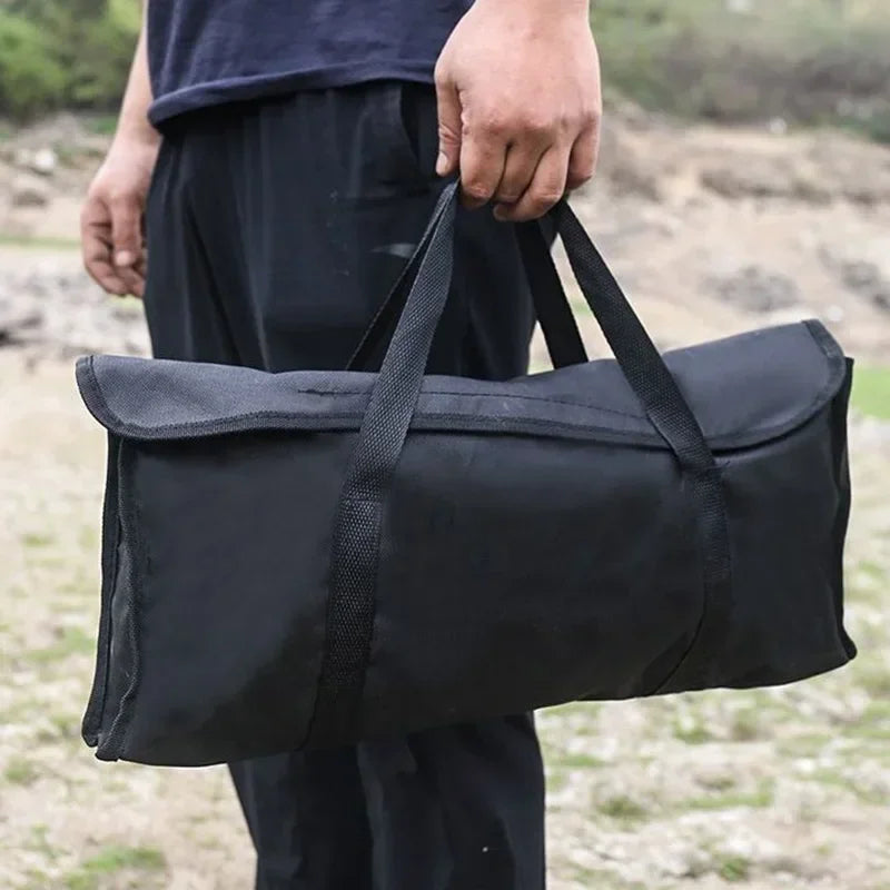 Black fabric carry bag with long handle straps for portable folding grill