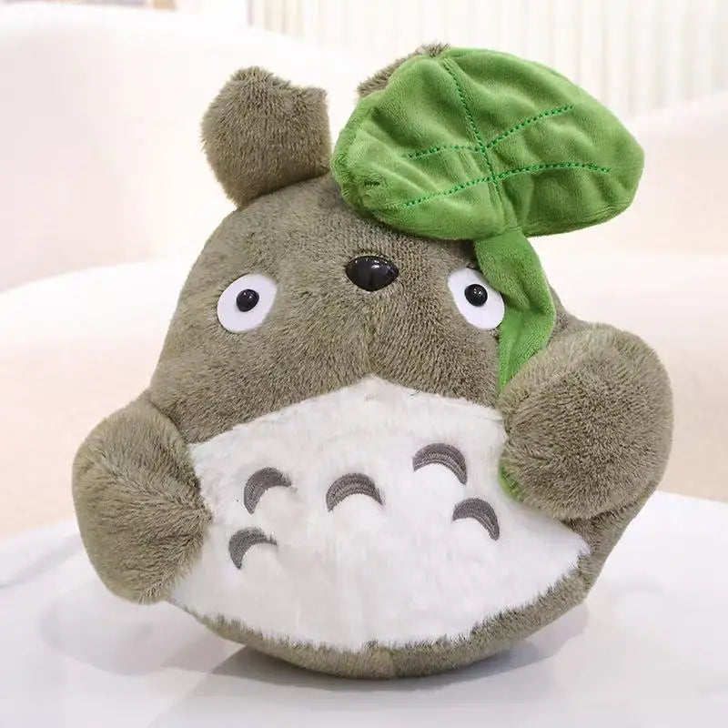 Cartoon forest creature plush pillow, brown teddy with green leaf cap and white belly pad