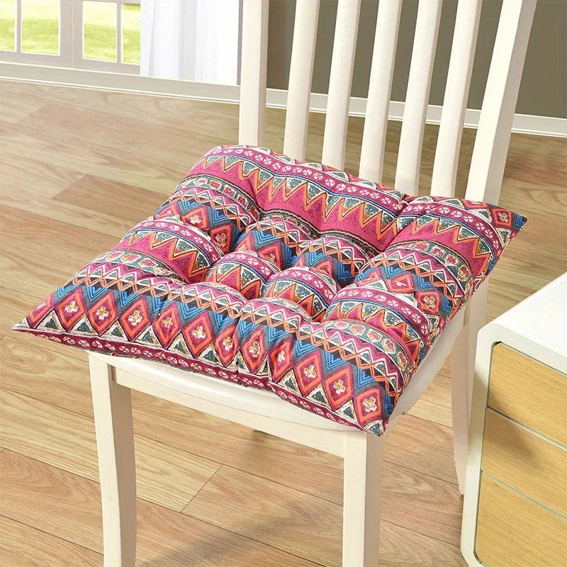 Red-and-blue patterned square seat cushion with carrying strap on chair
