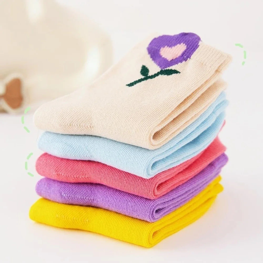 Stack of girls crew socks in cream, light blue, pink, purple, and yellow with heart flowers