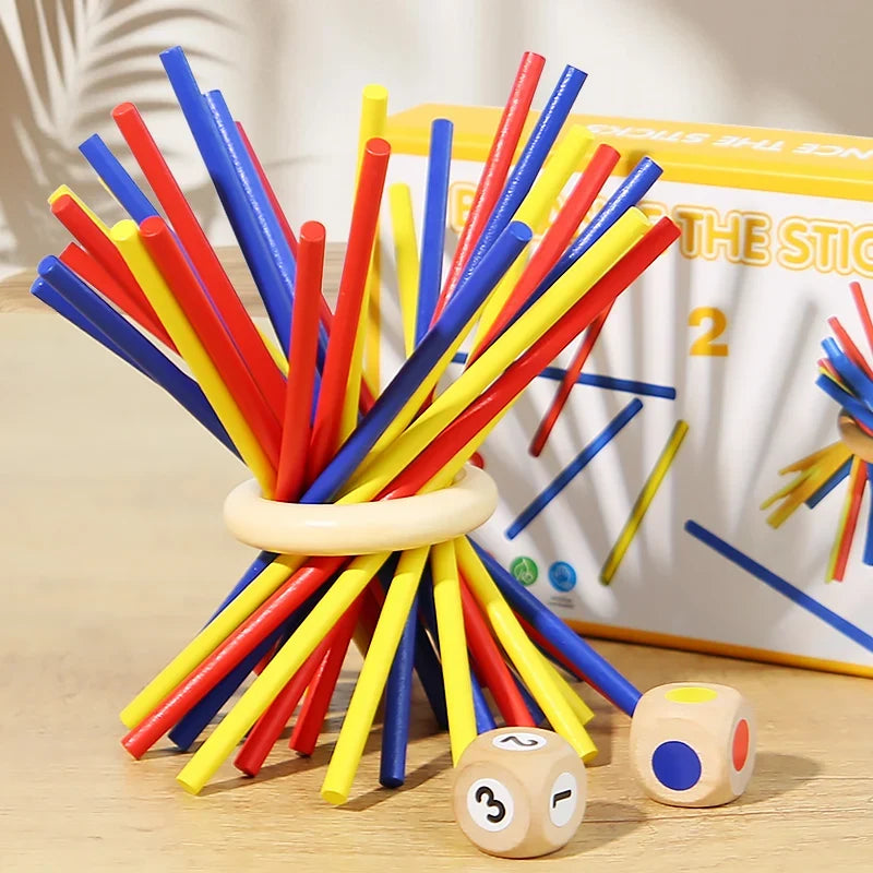 Colorful wooden sticks stacked in a ring with two wooden dice on table