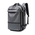 Grey 17-inch laptop backpack with front zip pocket, top handle, and padded straps