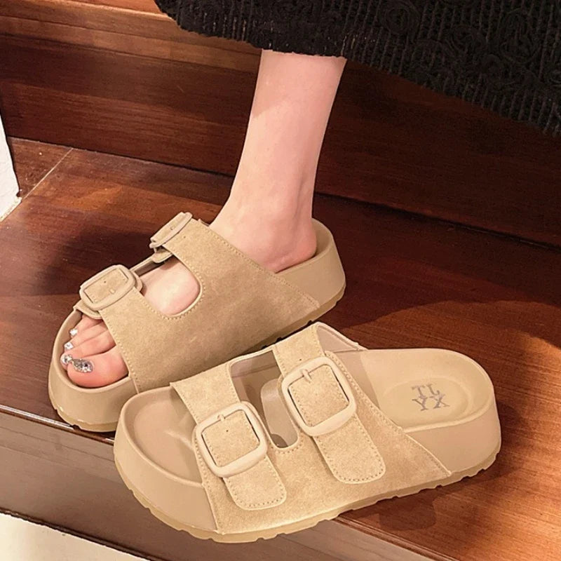 Women’s platform slide sandals with double buckle straps, light beige color.