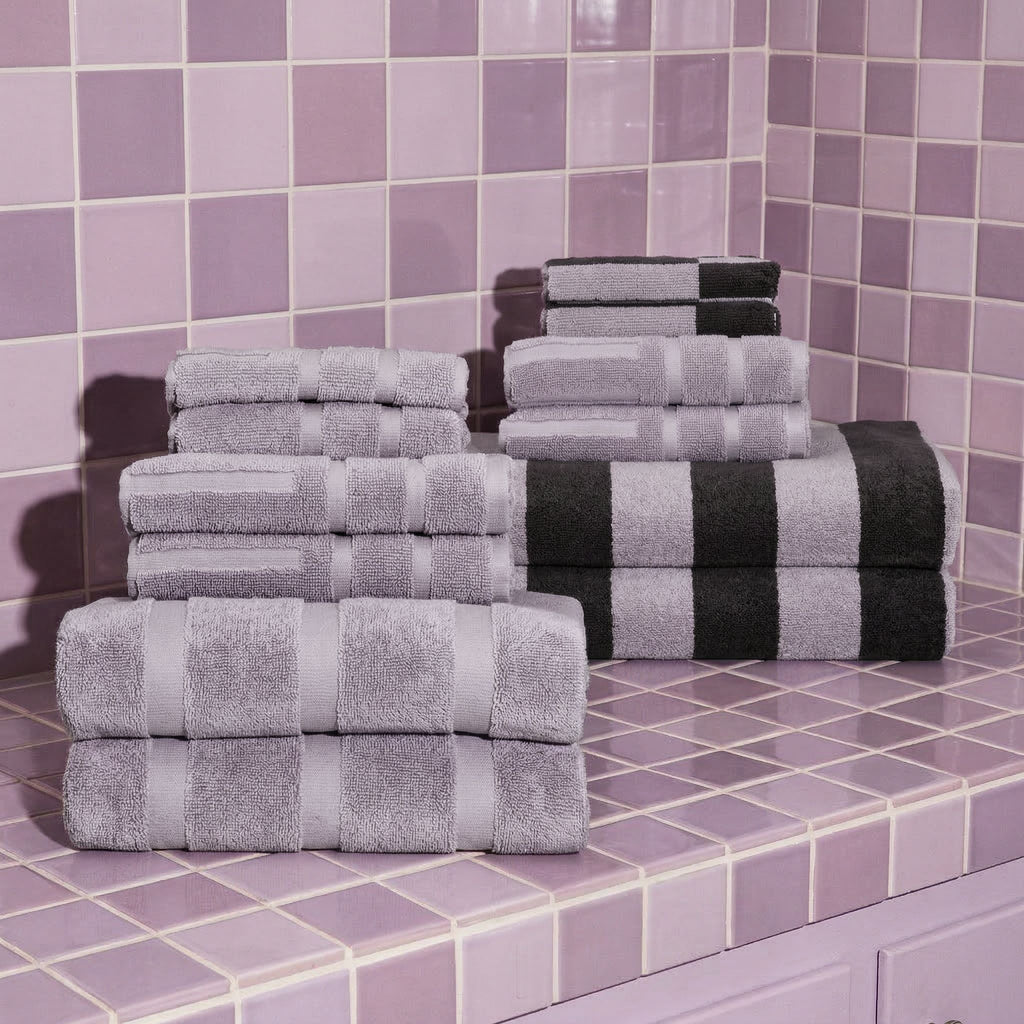 Lilac and white checkered cotton towel stacks with dark folded towels on top