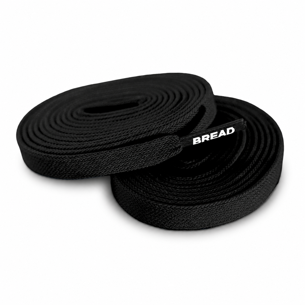 Black elastic shoelaces coiled in loops, with BREAD logo detail