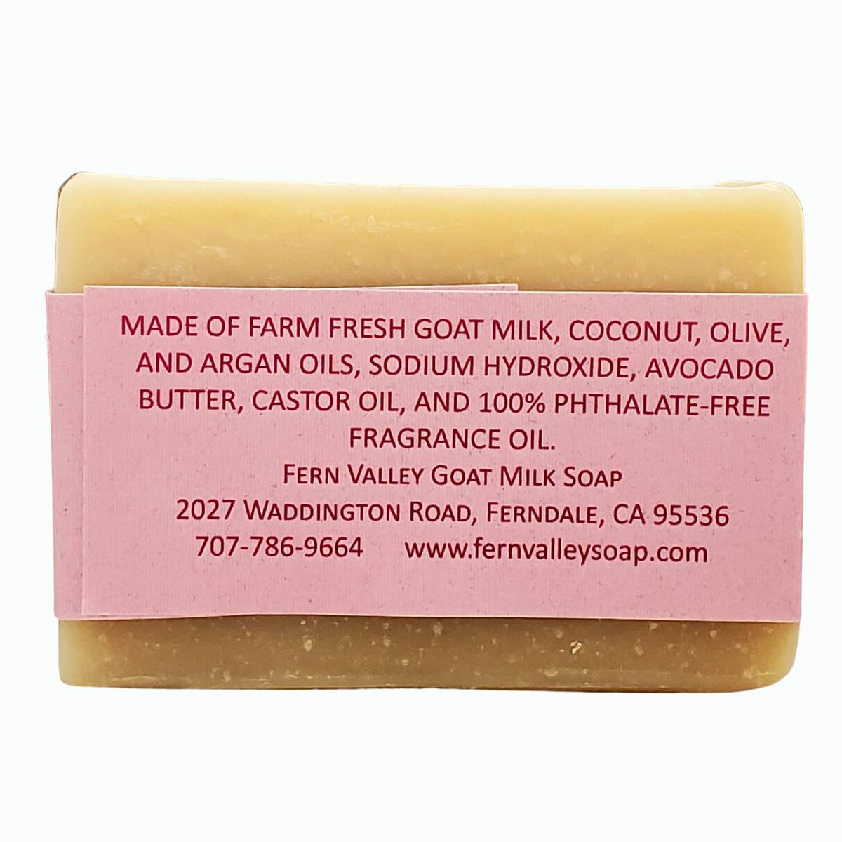 Handmade shampoo soap bar with pink ingredient label and tan bar, flat back view