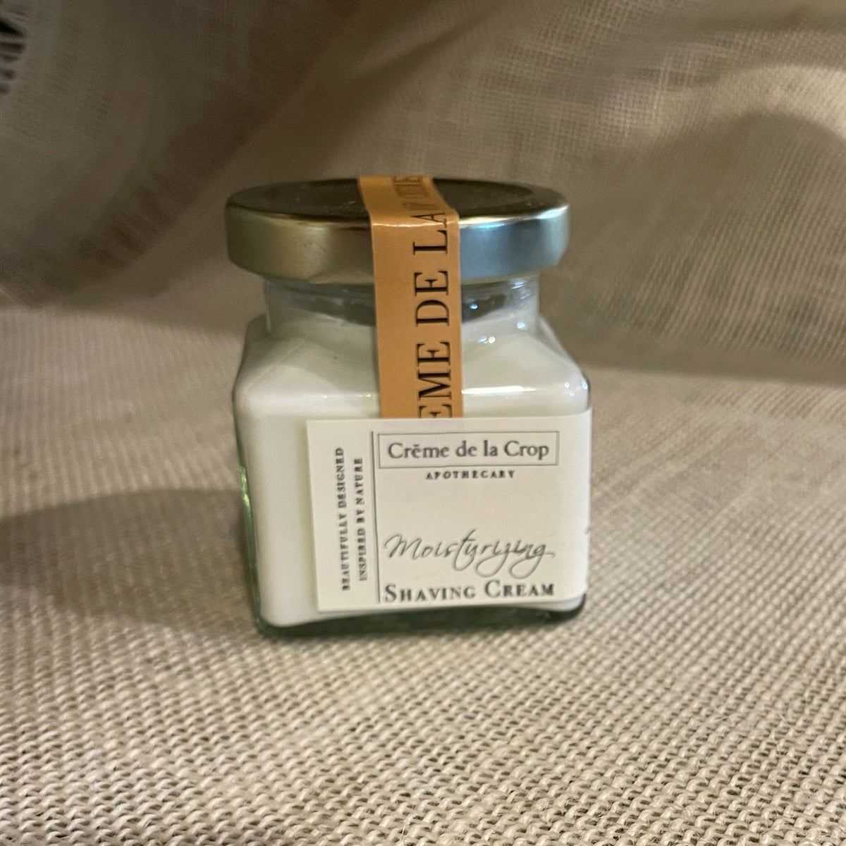Creme de la Crop Apothecary moisturizing shaving cream jar with gold lid