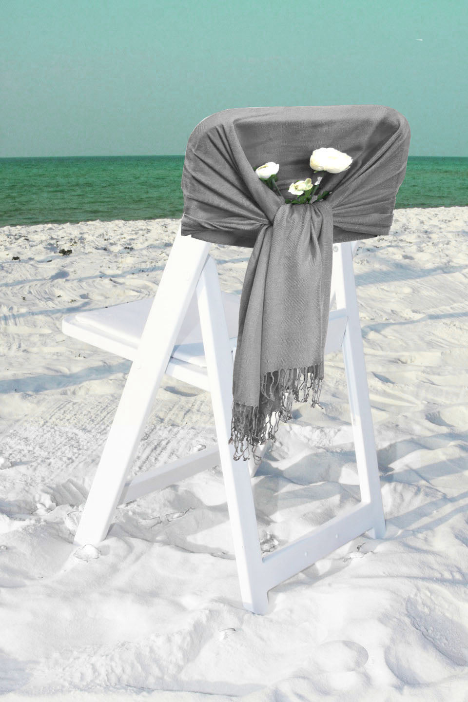 Dark gray pashmina-style shawl wrap scarf draped over a chair with fringe