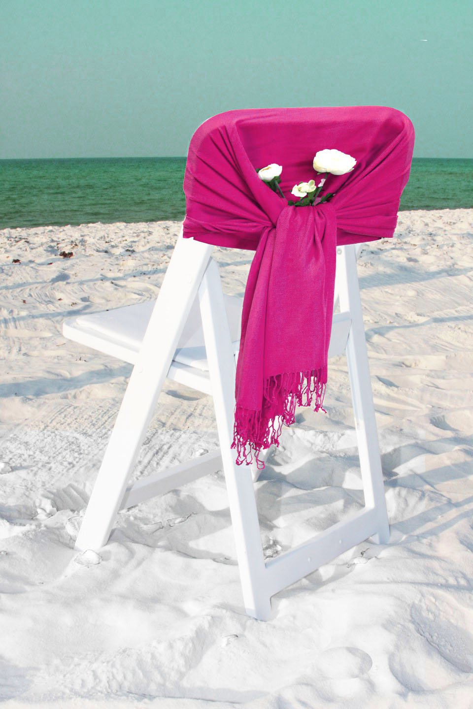 Silky pashmina-style shawl wrap in bright magenta, draped and finished with fringe.