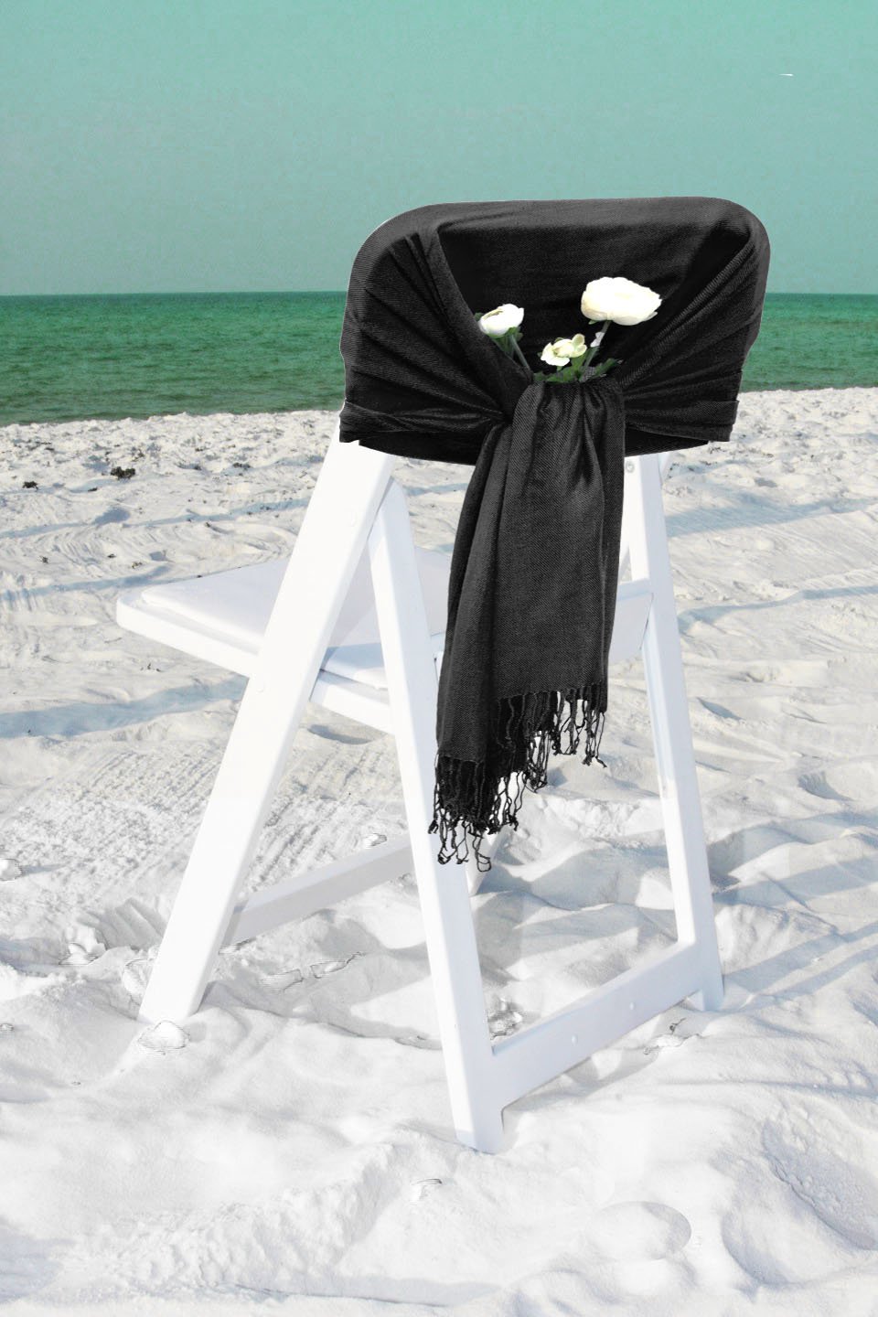 Pashmina-feel shawl wrap scarf in dark charcoal, draped over chair, fringed ends