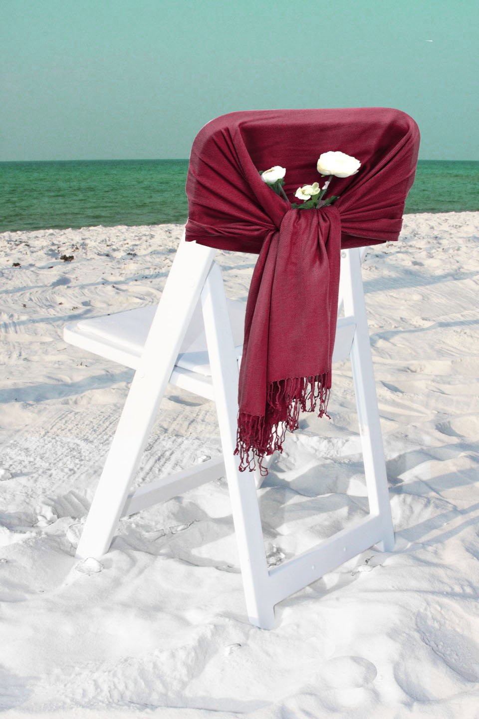 Burgundy solid pashmina-feel shawl scarf wrap with fringe, draped over a stool
