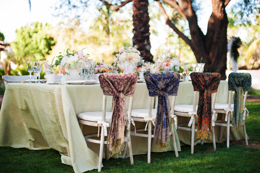 Double-layer jacquard paisley pashmina shawl with fringe, draped on chairs in blue and burgundy