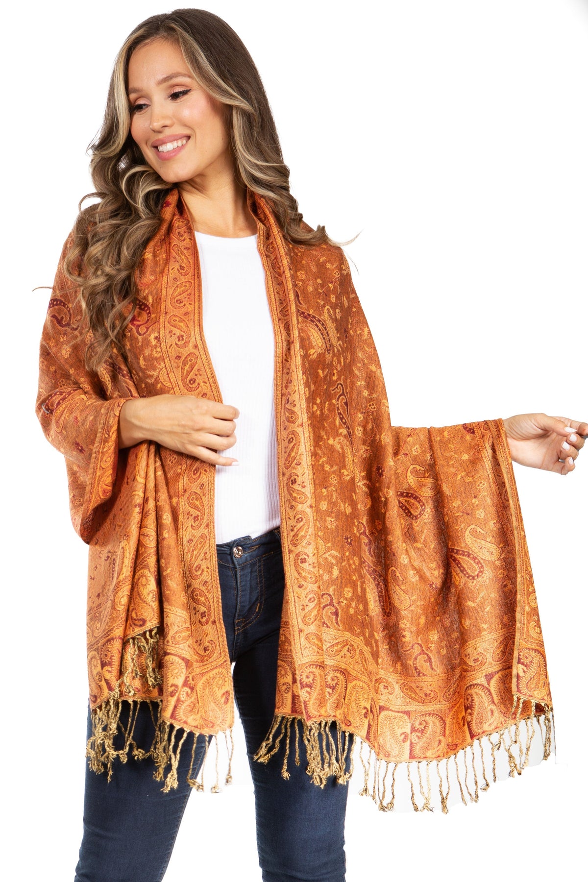 Orange paisley pashmina shawl with fringe trim, open wrap over white top and jeans