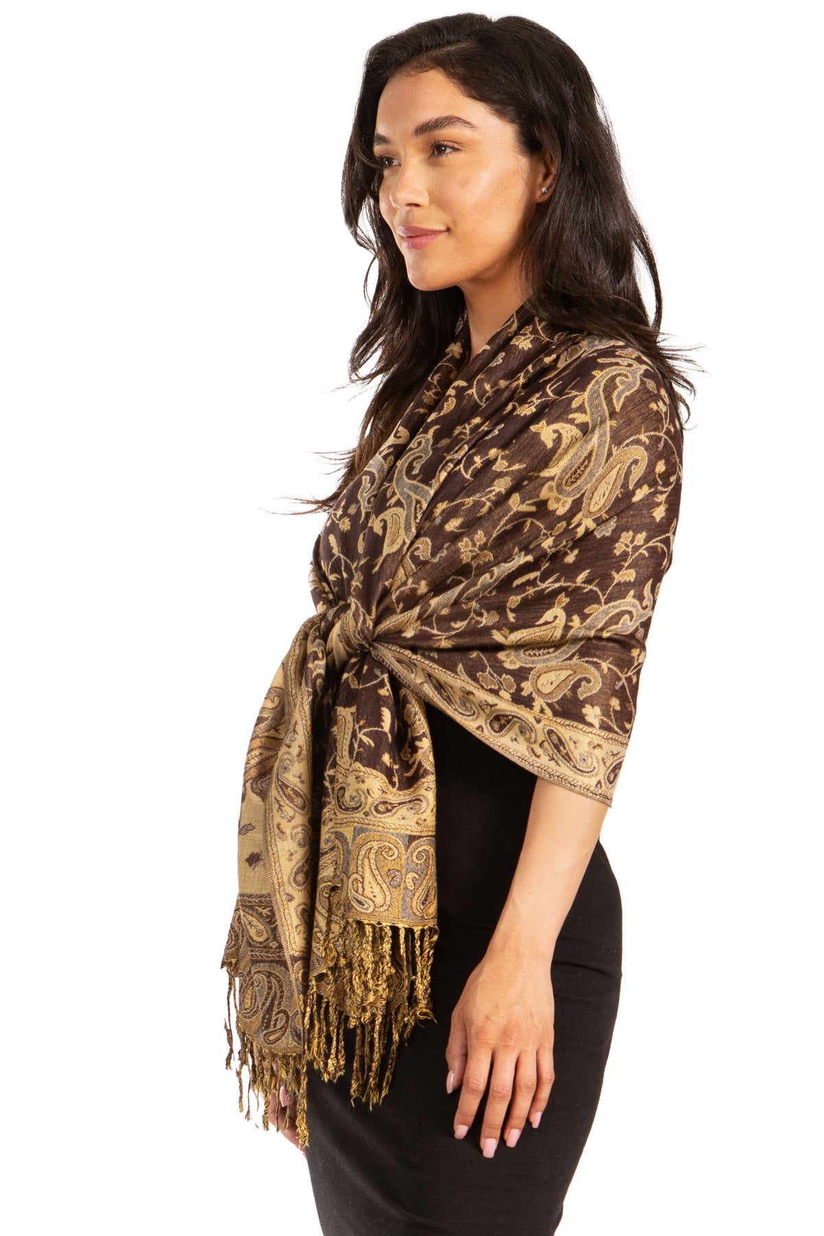 Brown and gold paisley pashmina shawl with fringe trim, tied at front