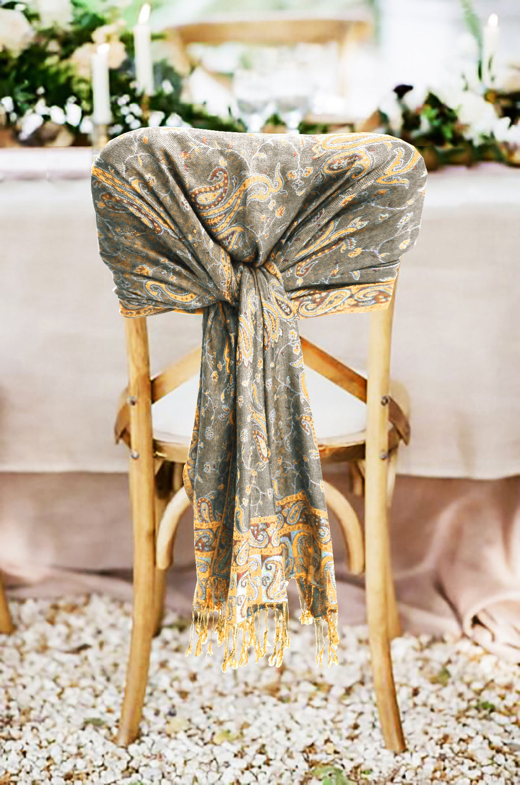Grey and gold paisley pashmina shawl with fringed ends tied in a knot