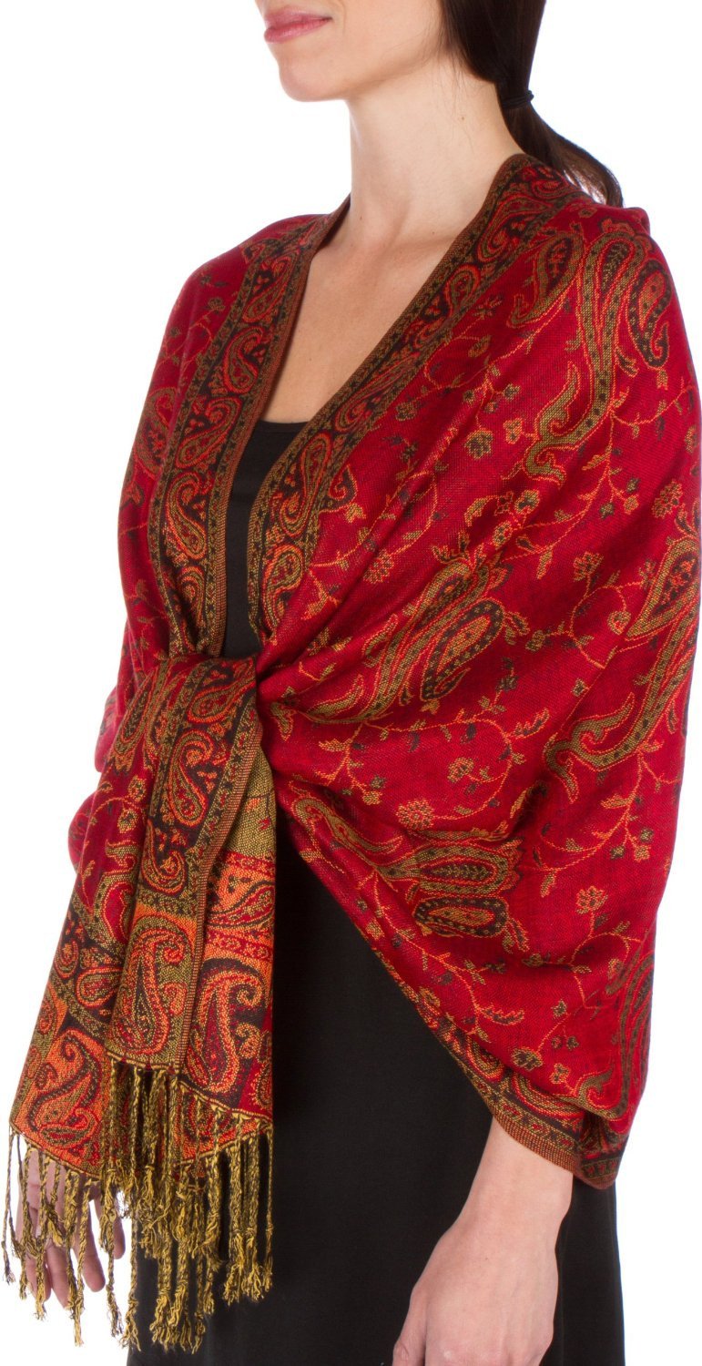Red paisley pashmina shawl with ornate motifs and gold fringe trim, worn